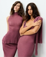 A MODEL POSES WEARING SKIMS CLOTHING