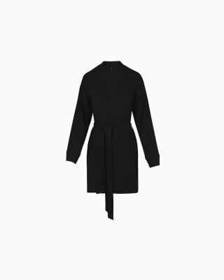 A MODEL POSES WEARING SKIMS ROBES