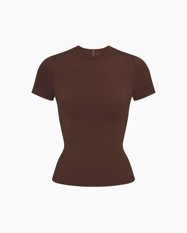 A MODEL POSES WEARING SKIMS