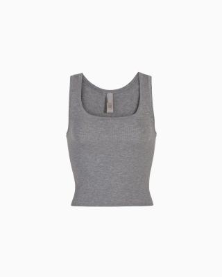 A MODEL POSES WEARING SKIMS COTTON RIB IN KYANITE