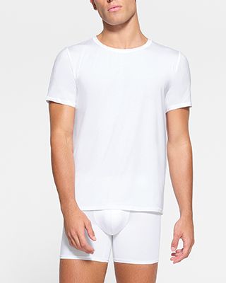 A model poses wearing SKIMS MENS STRETCH