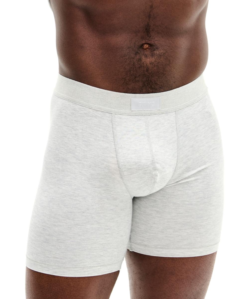 A MODEL POSES WEARING SKIMS MENS BOXERS