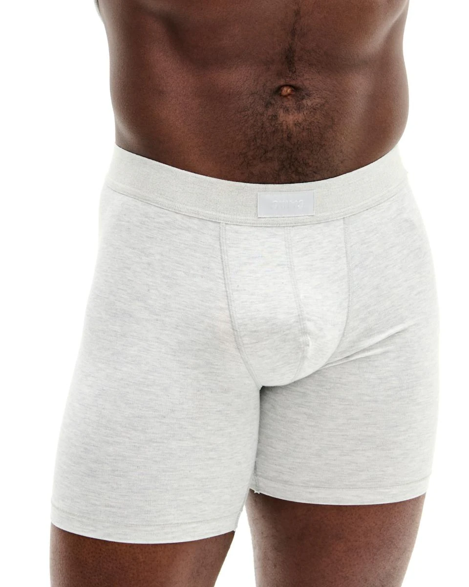 A MODEL POSES WEARING SKIMS MENS SPORT