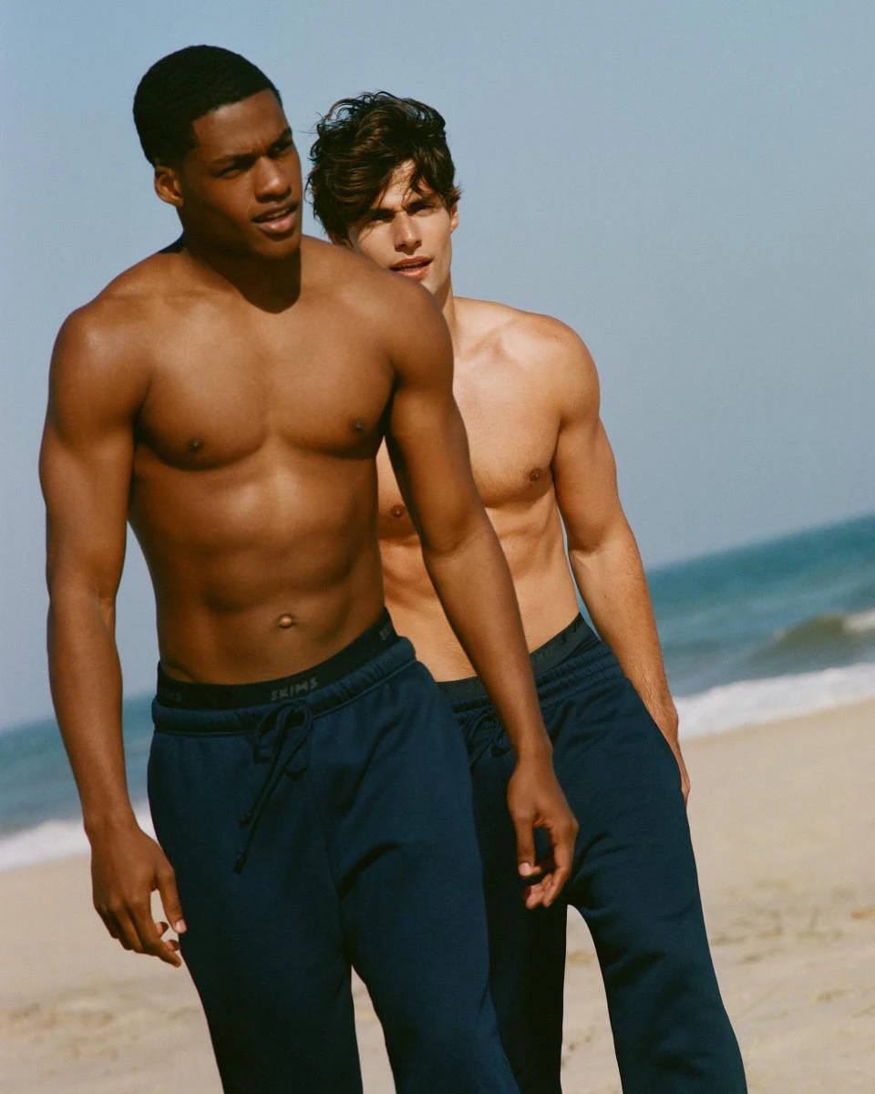 A MODEL POSES WEARING SKIMS MENS SPORT