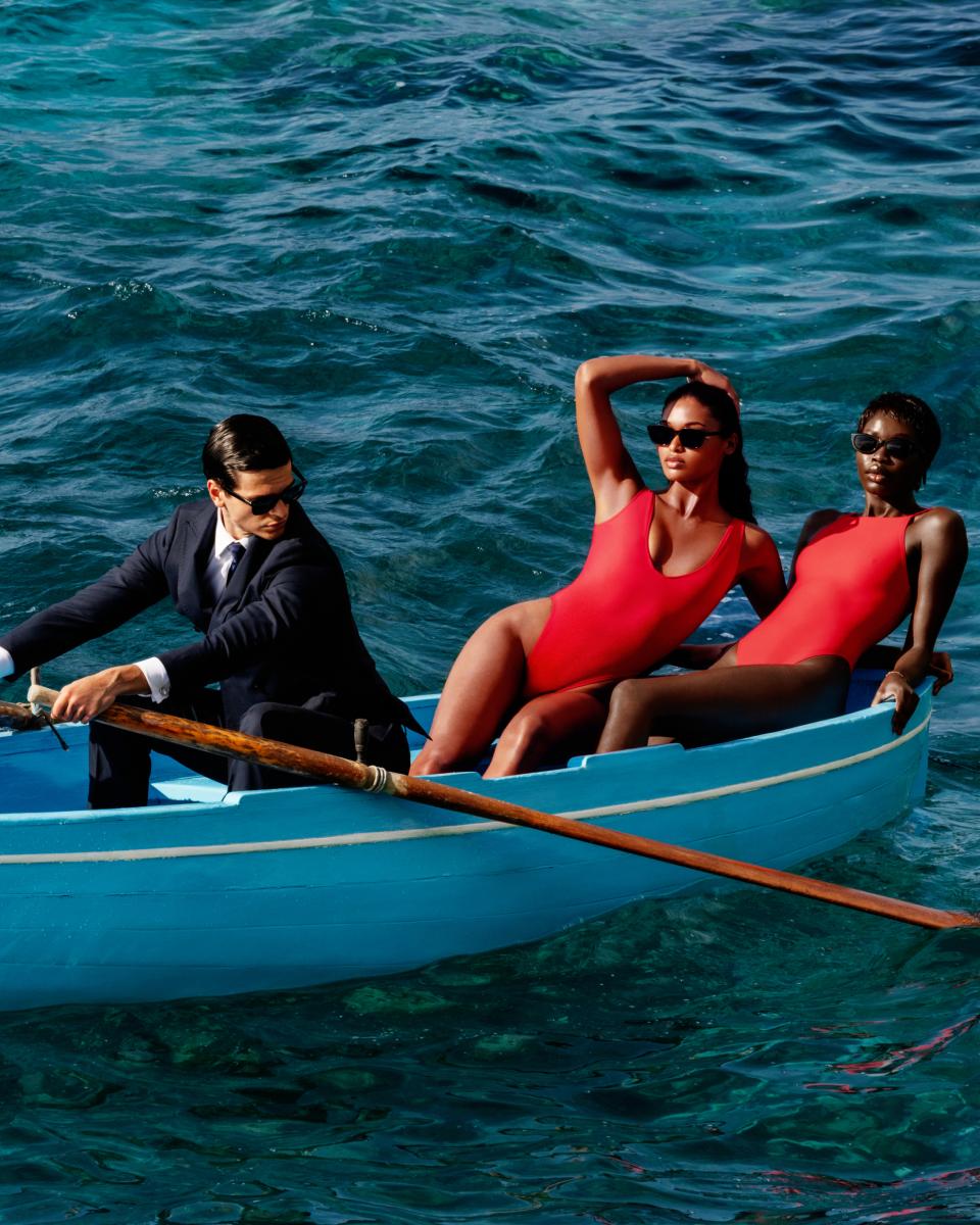 A MODEL POSES WEARING SKIMS ONE PIECE SWIMSUIT