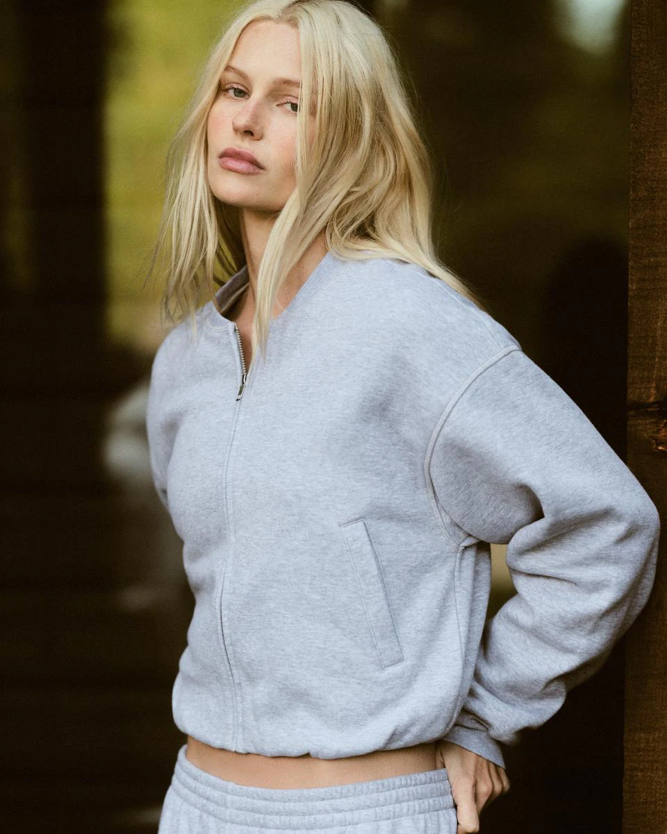 A MODEL POSES WEARING SKIMS CLOTHING