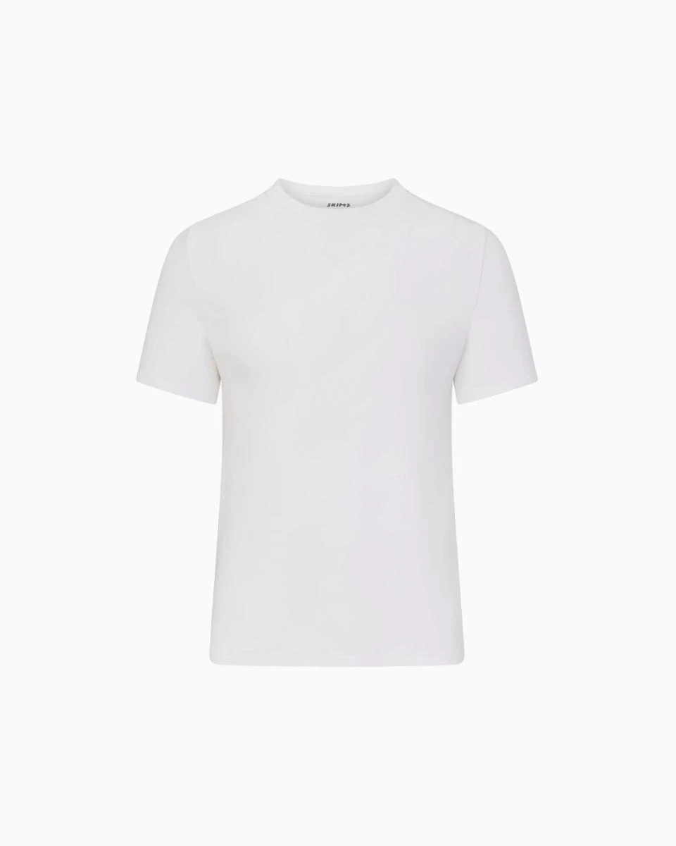 A MODEL POSES WEARING SKIMS MENS STRETCH T-SHIRT