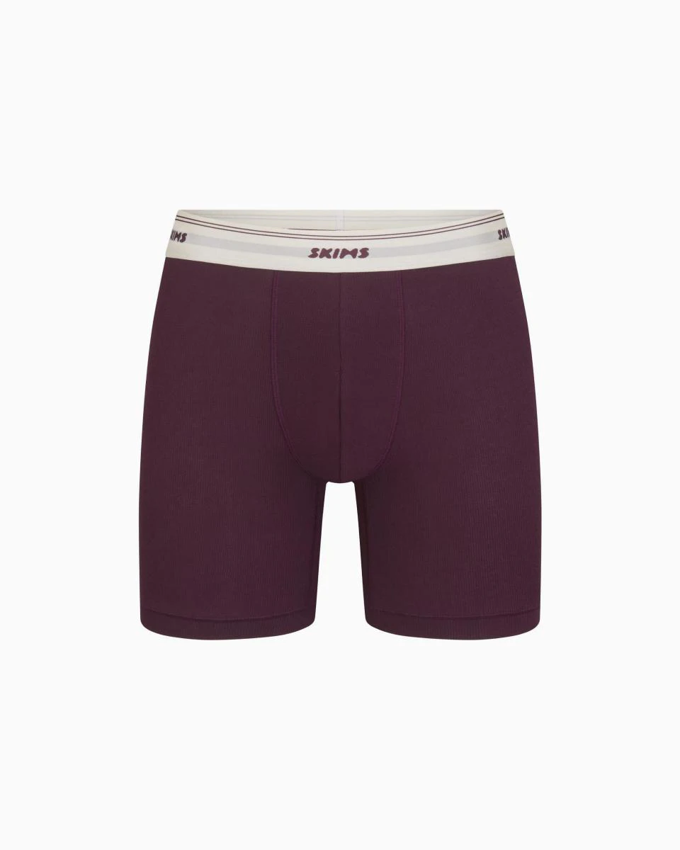 A MODEL POSES WEARING SKIMS MENS BOXERS