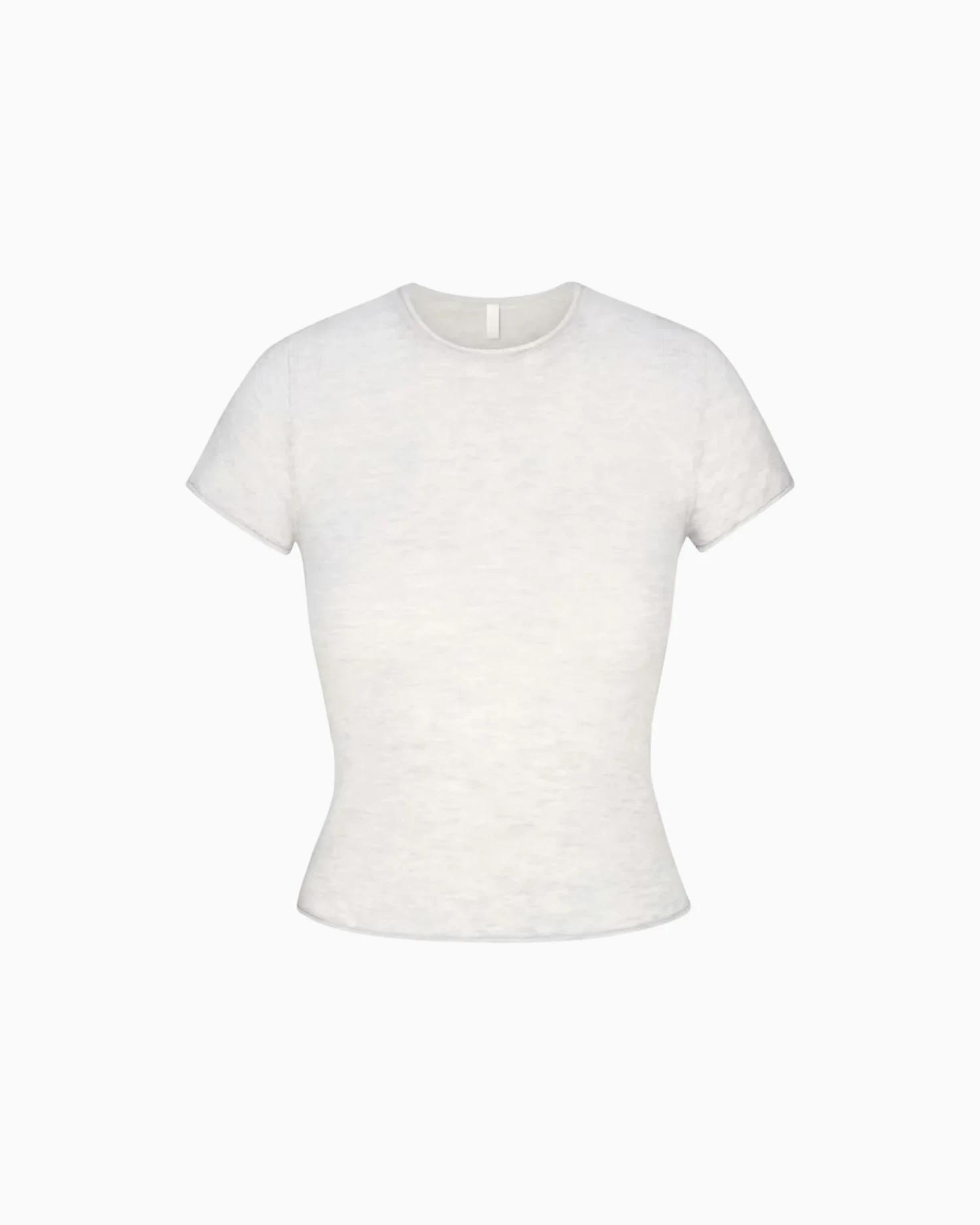 A MODEL POSES WEARING SKIMS COTTON T-SHIRT