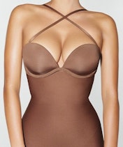 A model wears the EVERYDAY SCULPT HIGH-WAISTED MID THIGH SHORT