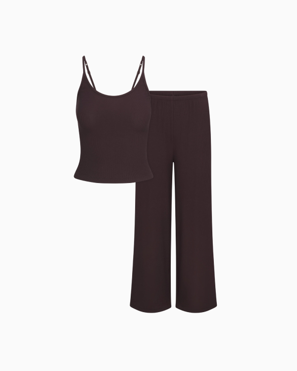 A MODEL POSES WEARING SKIMS CLOTHING