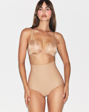 A model wears the EVERYDAY SCULPT HIGH-WAISTED MID THIGH SHORT