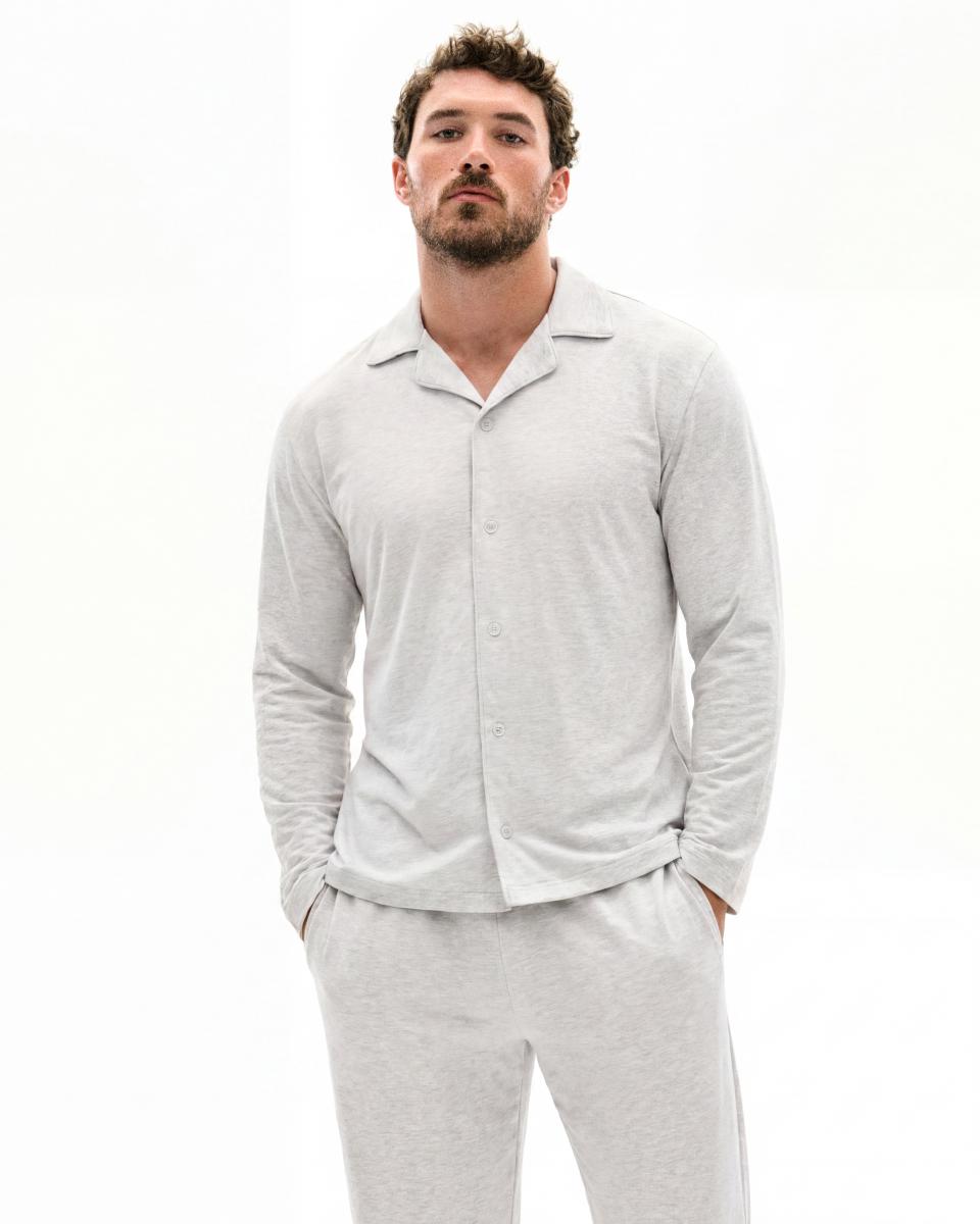A MODEL POSES WEARING SKIMS MENS PAJAMAS