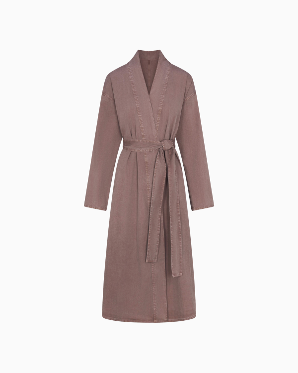 A MODEL POSES WEARING SKIMS ROBES