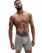 A MODEL POSES WEARING SKIMS MENS BOXERS