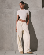 A MODEL POSES WEARING SKIMS CLOTHING