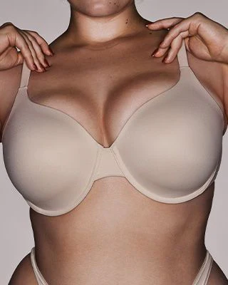 A MODEL POSES WEARING T-SHIRT BRA