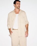 A MODEL POSES WEARING SKIMS MENS PAJAMAS