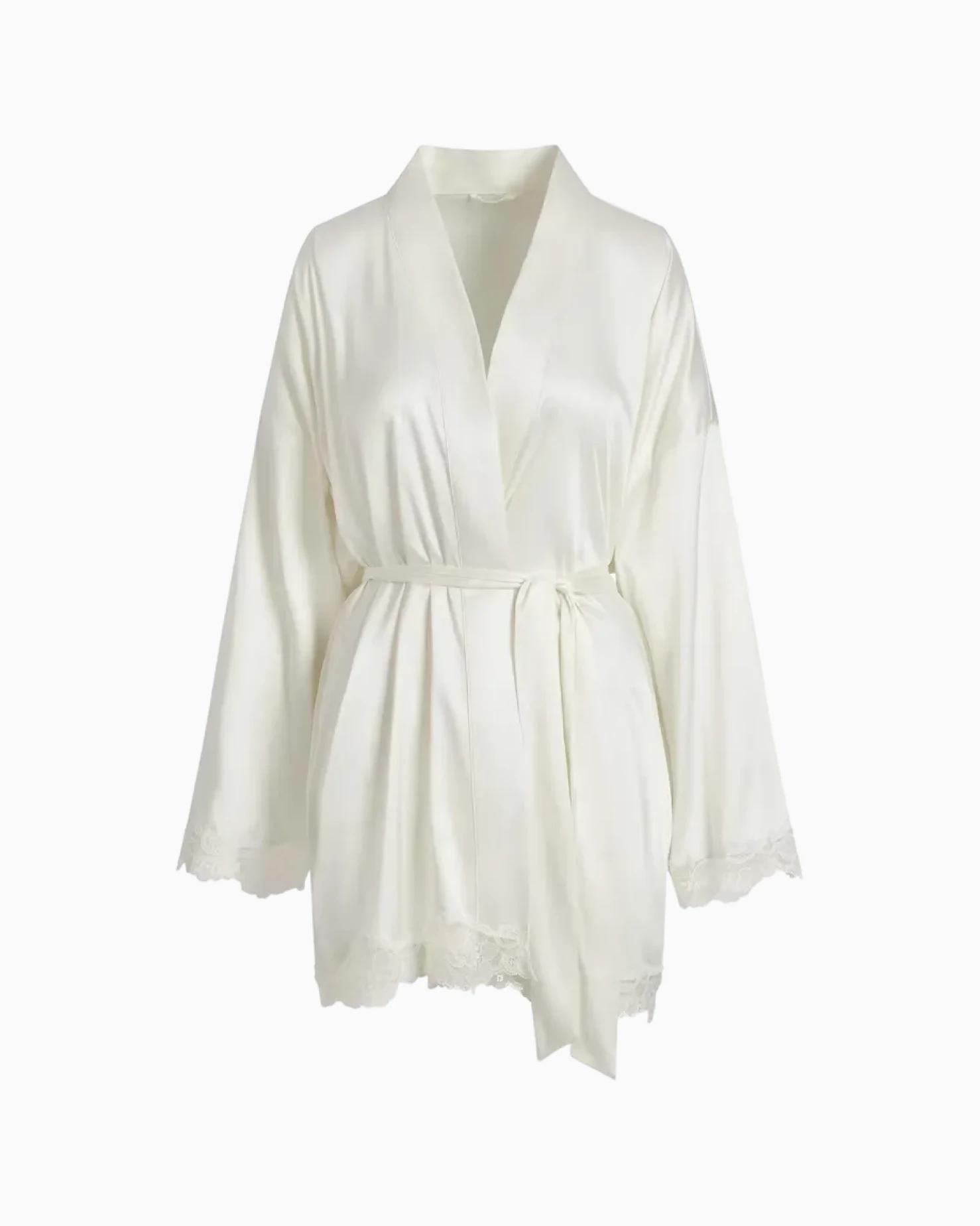 A MODEL POSES WEARING SKIMS ROBES