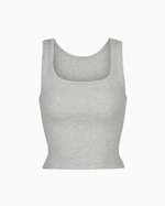 A MODEL POSES WEARING SKIMS COTTON RIB TANK